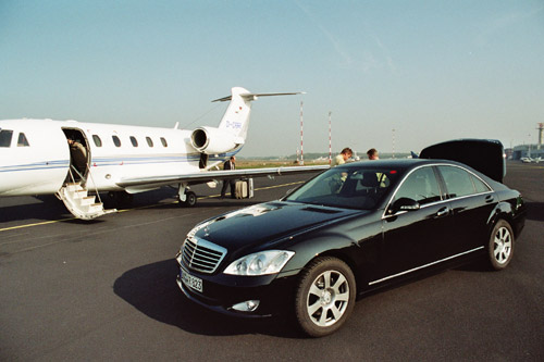 Chauffeur and Limousine at the runway of airport Münster
